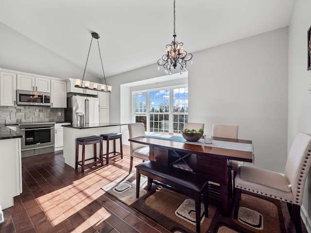 dining room featuring a notable chandelier, dark wood finished floors, and lofted ceiling
