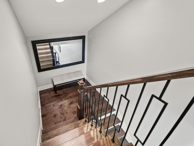 stairway with recessed lighting, baseboards, and wood finished floors