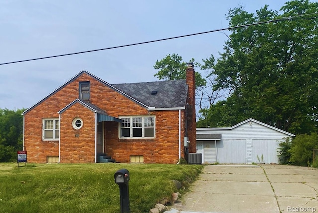 3052 S Center Rd, Burton, MI 48519 - view of front of home with brick siding, a chimney, a front yard, entry steps, and driveway
