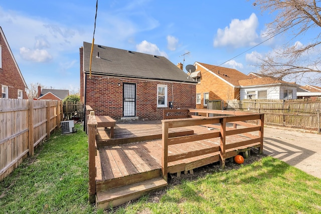 14035 Collingham Dr, Detroit, MI 48205 - back of house with roof with shingles, brick siding, a fenced backyard, a wooden deck, and a yard