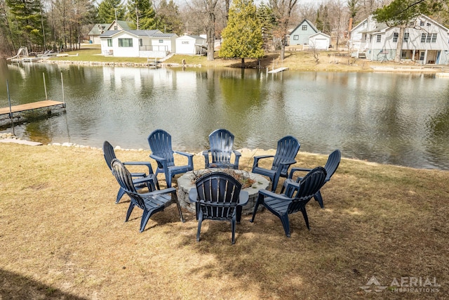 exterior space featuring a fire pit, a residential view, and a water view