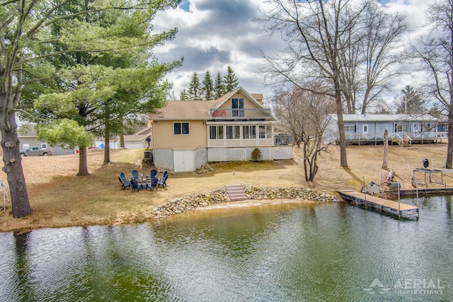 rear view of house featuring a deck with water view