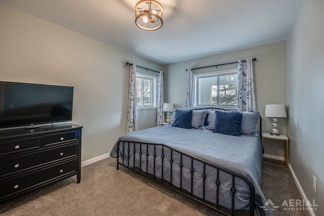 bedroom featuring baseboards, a notable chandelier, and carpet flooring