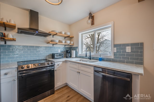kitchen featuring wall chimney exhaust hood, a sink, white cabinetry, open shelves, and appliances with stainless steel finishes