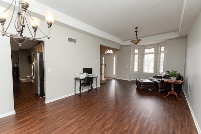 1527 Somerset Ct, Mount Pleasant, MI 48858 - foyer entrance featuring dark wood-type flooring, visible vents, baseboards, and a chandelier