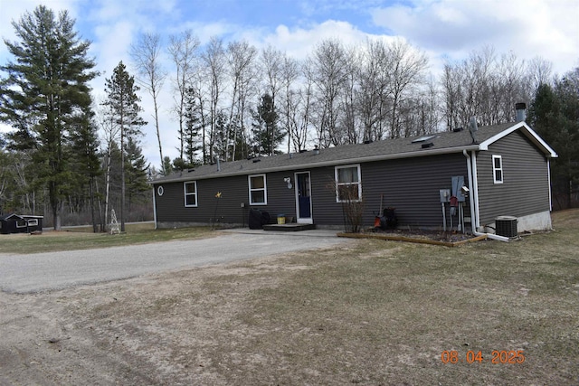 view of front of property featuring central air condition unit and a front yard