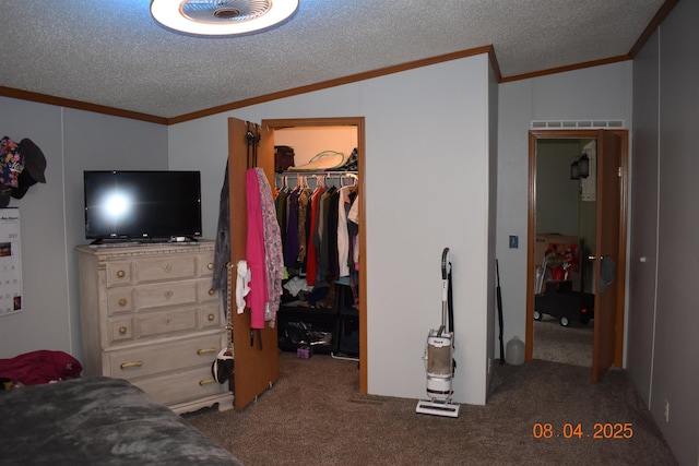 carpeted bedroom with a closet, vaulted ceiling, ornamental molding, a textured ceiling, and a walk in closet