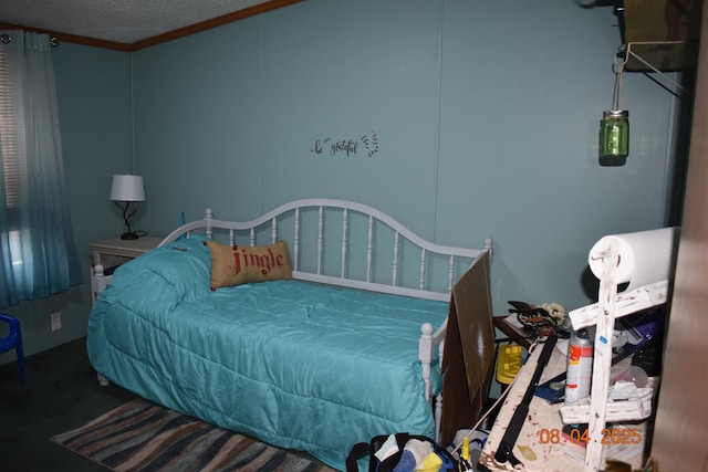carpeted bedroom featuring a textured ceiling and crown molding