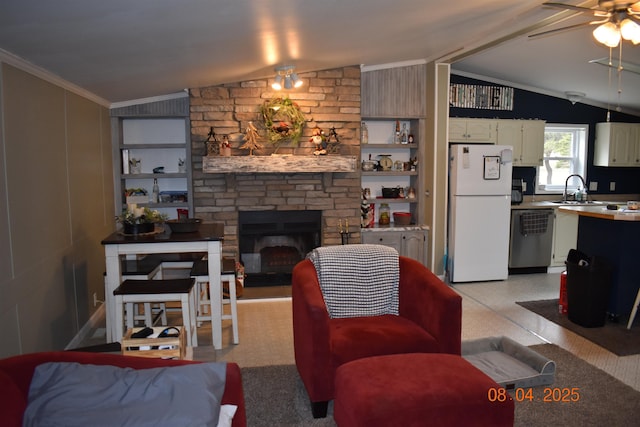 living room with crown molding, a stone fireplace, a ceiling fan, and lofted ceiling