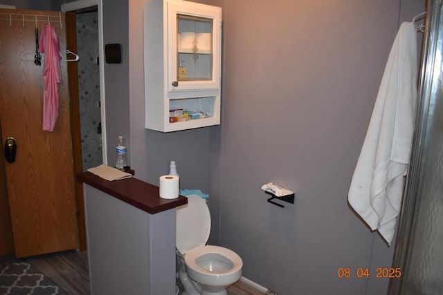 bathroom featuring toilet and wood finished floors