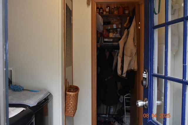 clothes washing area featuring independent washer and dryer and laundry area