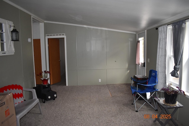 interior space with carpet flooring, visible vents, and crown molding