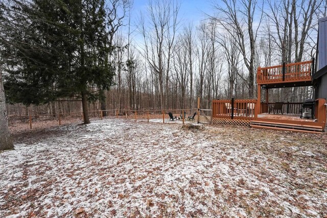 9341 W M-115, Mesick, MI 49668 - yard layered in snow featuring a deck and a fenced backyard