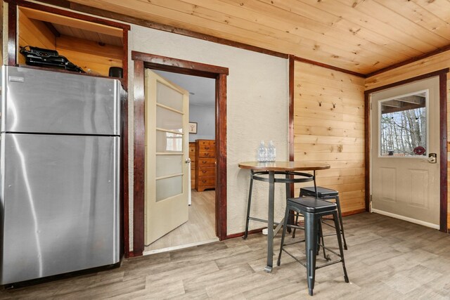9341 W M-115, Mesick, MI 49668 - dining room featuring wood walls, light wood-style flooring, plenty of natural light, and wood ceiling