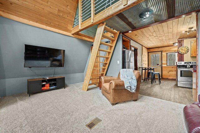 9341 W M-115, Mesick, MI 49668 - living room with wooden walls, visible vents, carpet, and wood finished floors