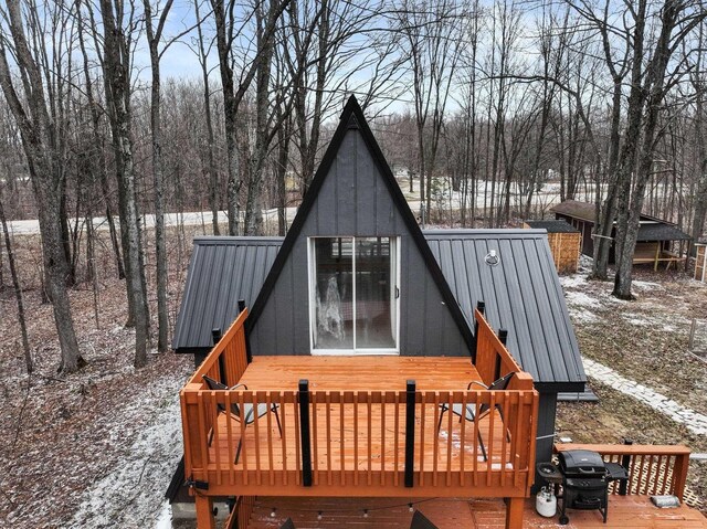 9341 W M-115, Mesick, MI 49668 - rear view of house with a wooden deck, metal roof, and a standing seam roof
