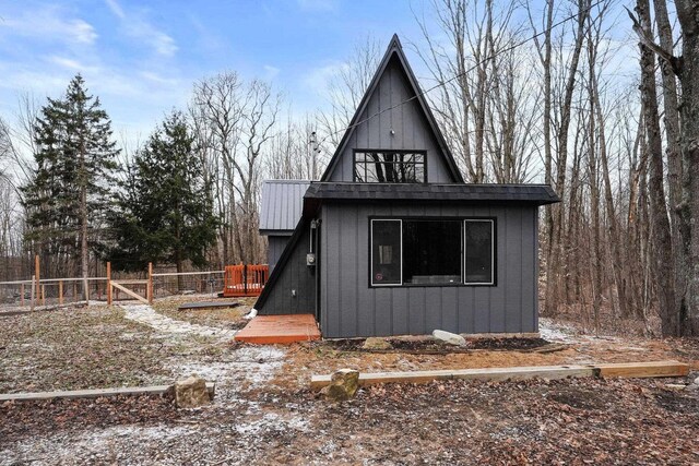 9341 W M-115, Mesick, MI 49668 - exterior space featuring an outbuilding, fence, and board and batten siding
