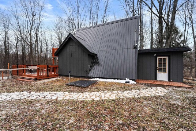9341 W M-115, Mesick, MI 49668 - view of side of home featuring a wooden deck and metal roof