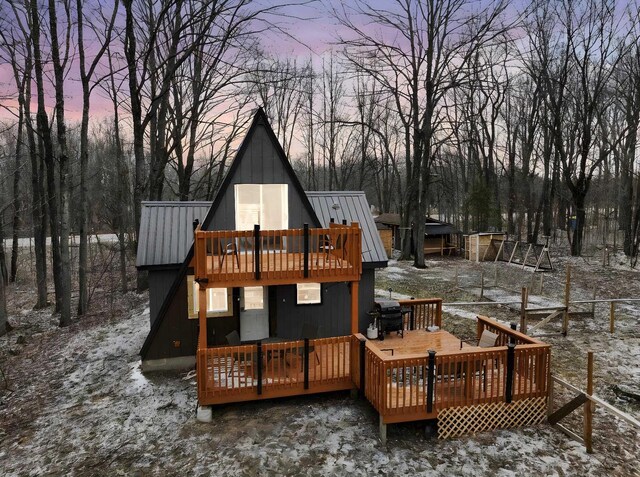9341 W M-115, Mesick, MI 49668 - back of house featuring a wooden deck, metal roof, and a standing seam roof