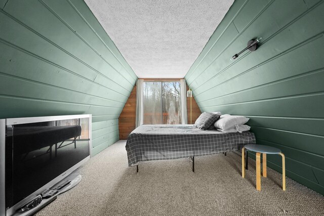 9341 W M-115, Mesick, MI 49668 - bedroom featuring wood walls, carpet flooring, lofted ceiling, and a textured ceiling