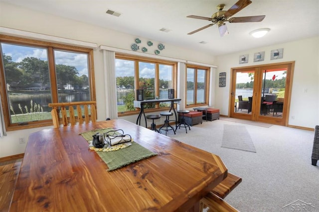 dining area featuring a ceiling fan, baseboards, visible vents, and french doors
