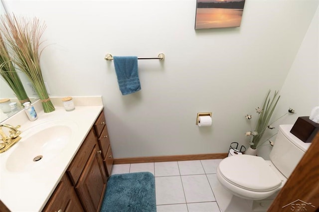 bathroom with toilet, baseboards, tile patterned flooring, and vanity