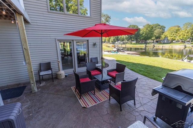 view of patio / terrace with a water view and grilling area