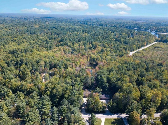 bird's eye view featuring a wooded view