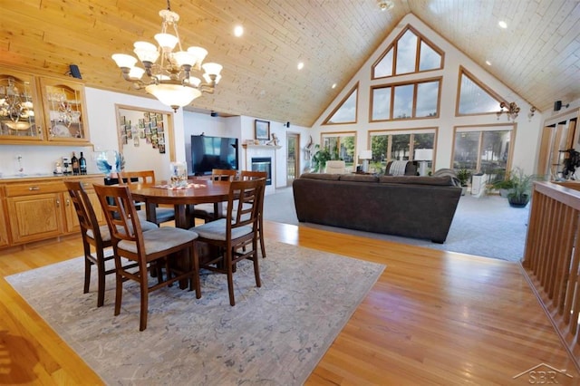dining room featuring light wood-style floors, recessed lighting, a notable chandelier, and high vaulted ceiling