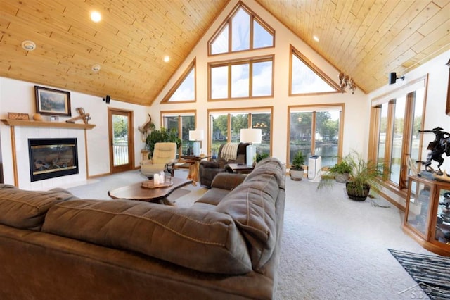 living area with carpet floors, high vaulted ceiling, and a tile fireplace
