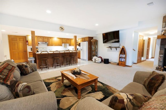 living area featuring recessed lighting and light carpet