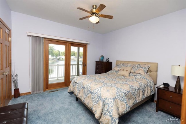 carpeted bedroom featuring baseboards, a ceiling fan, a water view, and access to exterior