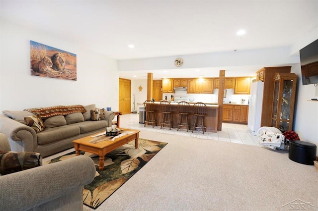 living area with recessed lighting and light colored carpet