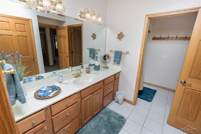 full bathroom with baseboards, tile patterned flooring, and vanity