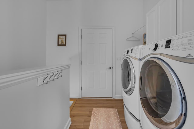 442 Constitution Ave, Brooklyn, MI 49230 - laundry room with washer and dryer, light wood-style flooring, and baseboards