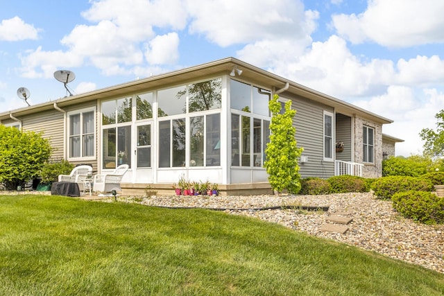 442 Constitution Ave, Brooklyn, MI 49230 - back of property featuring a sunroom and a lawn