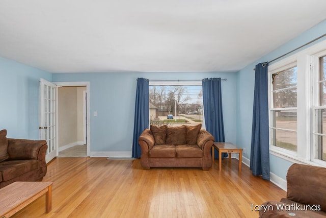 1193 E Apple Ave, Muskegon, MI 49442 - living room featuring baseboards and light wood-type flooring