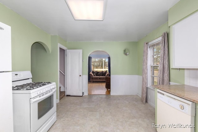 1193 E Apple Ave, Muskegon, MI 49442 - kitchen with a wealth of natural light, white appliances, white cabinetry, and light countertops