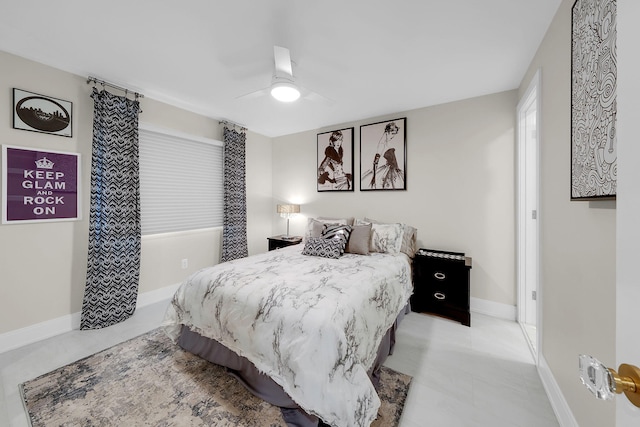 bedroom with ceiling fan and baseboards
