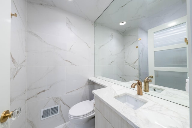 bathroom with visible vents, toilet, and vanity