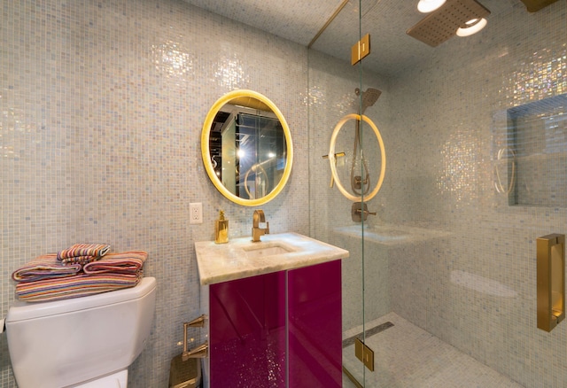 full bath with a shower stall, vanity, and toilet
