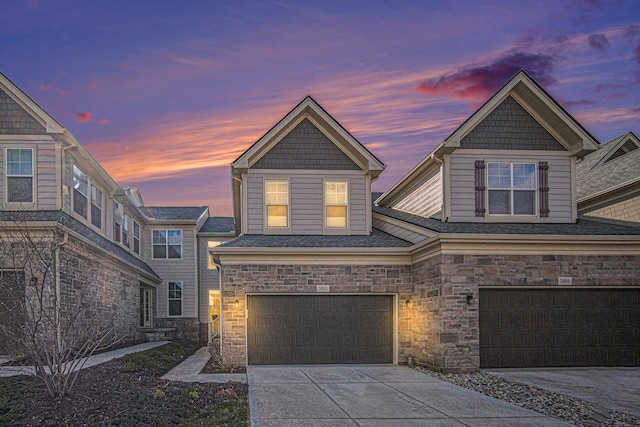 3092 N Spurway Dr, Ann Arbor, MI 48105 - view of front of home featuring an attached garage, stone siding, and driveway