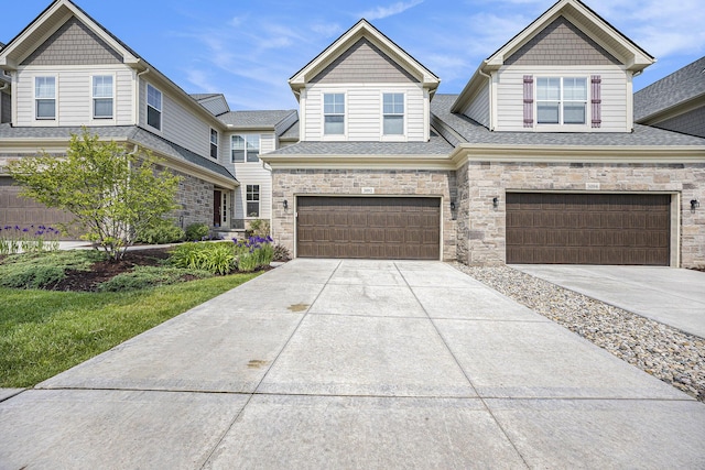 3092 N Spurway Dr, Ann Arbor, MI 48105 - view of front of home with a garage, driveway, roof with shingles, and stone siding
