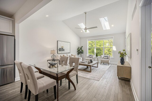 3092 N Spurway Dr, Ann Arbor, MI 48105 - dining area with a skylight, wood finished floors, baseboards, and high vaulted ceiling