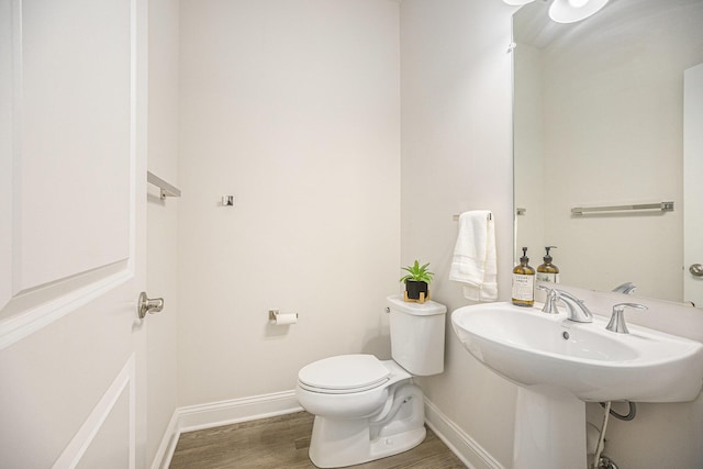 3092 N Spurway Dr, Ann Arbor, MI 48105 - bathroom featuring wood finished floors, toilet, and baseboards