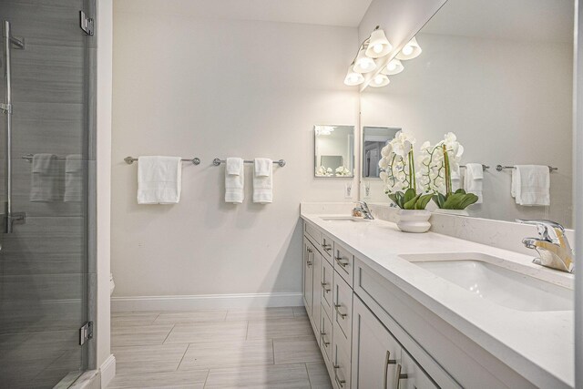 3092 N Spurway Dr, Ann Arbor, MI 48105 - bathroom featuring double vanity, baseboards, and a shower stall