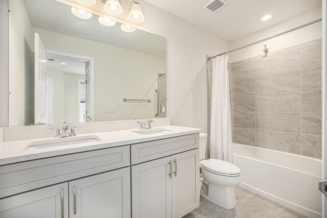 3092 N Spurway Dr, Ann Arbor, MI 48105 - full bath with double vanity, toilet, shower / bath combination with curtain, and tile patterned flooring