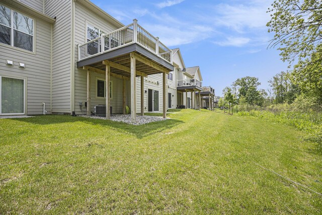 3092 N Spurway Dr, Ann Arbor, MI 48105 - view of green lawn featuring a deck and central AC unit