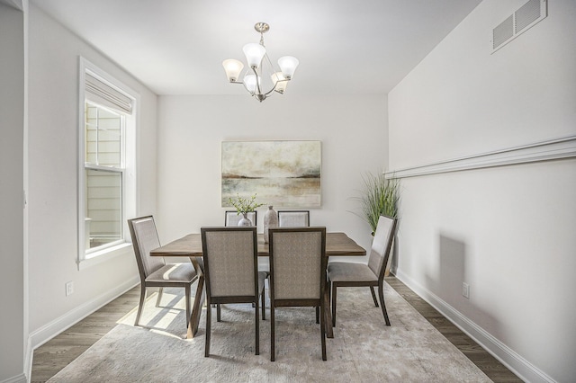 3092 N Spurway Dr, Ann Arbor, MI 48105 - dining area featuring a chandelier, wood finished floors, baseboards, and healthy amount of natural light