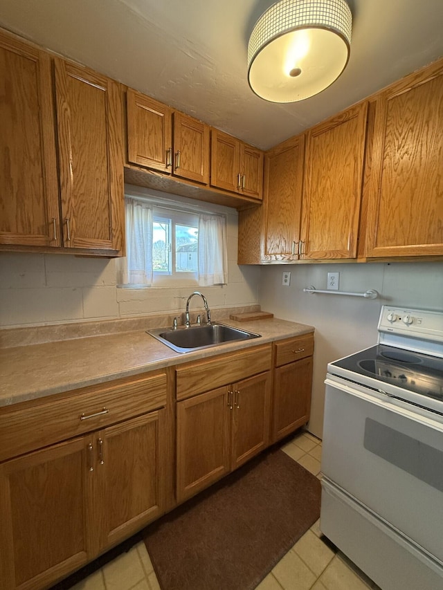 755 Bright Water Dr, Coldwater, MI 49036 - kitchen with white electric range oven, a sink, brown cabinets, light tile patterned flooring, and light countertops